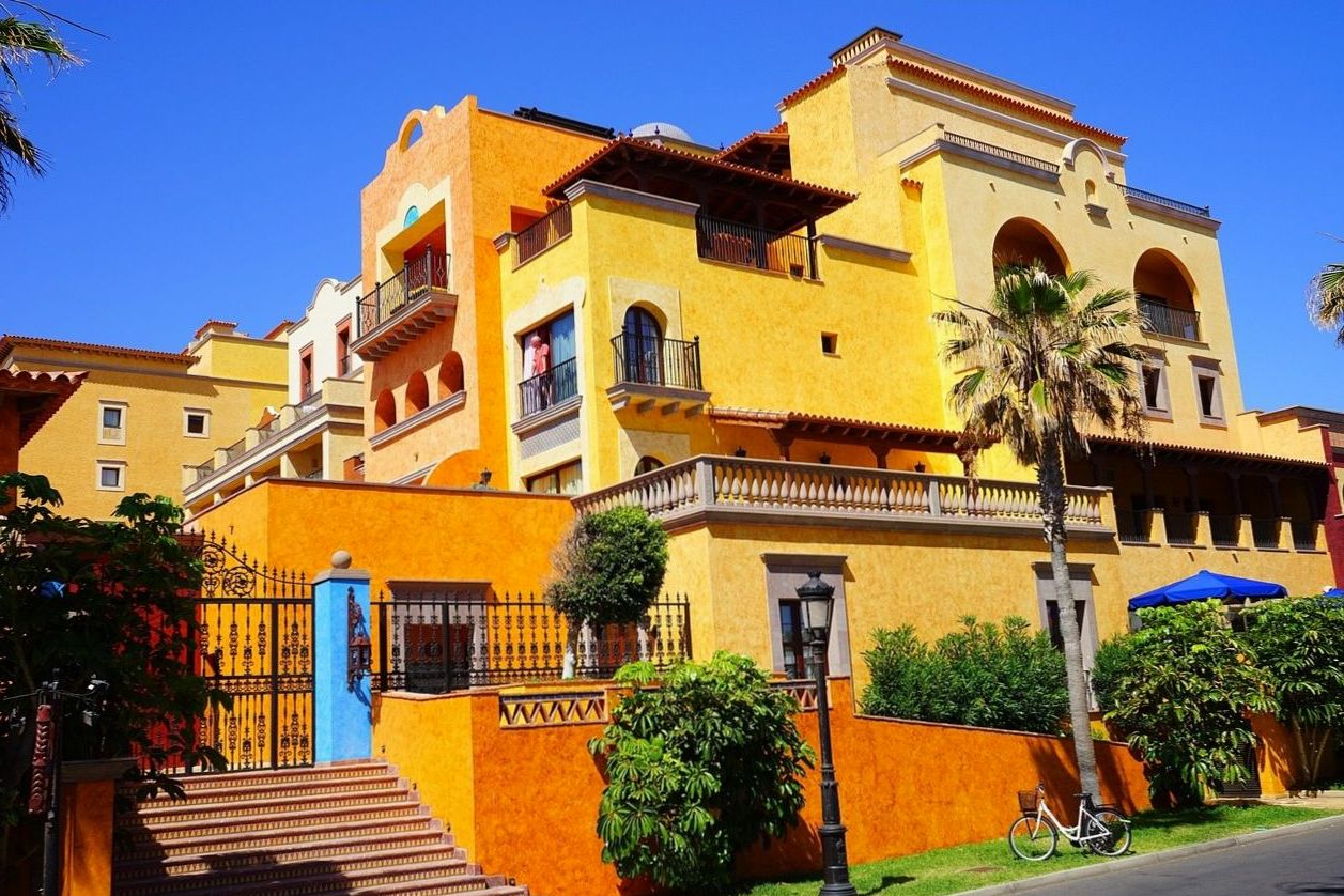 A charming yellow boutique hotel building at dusk